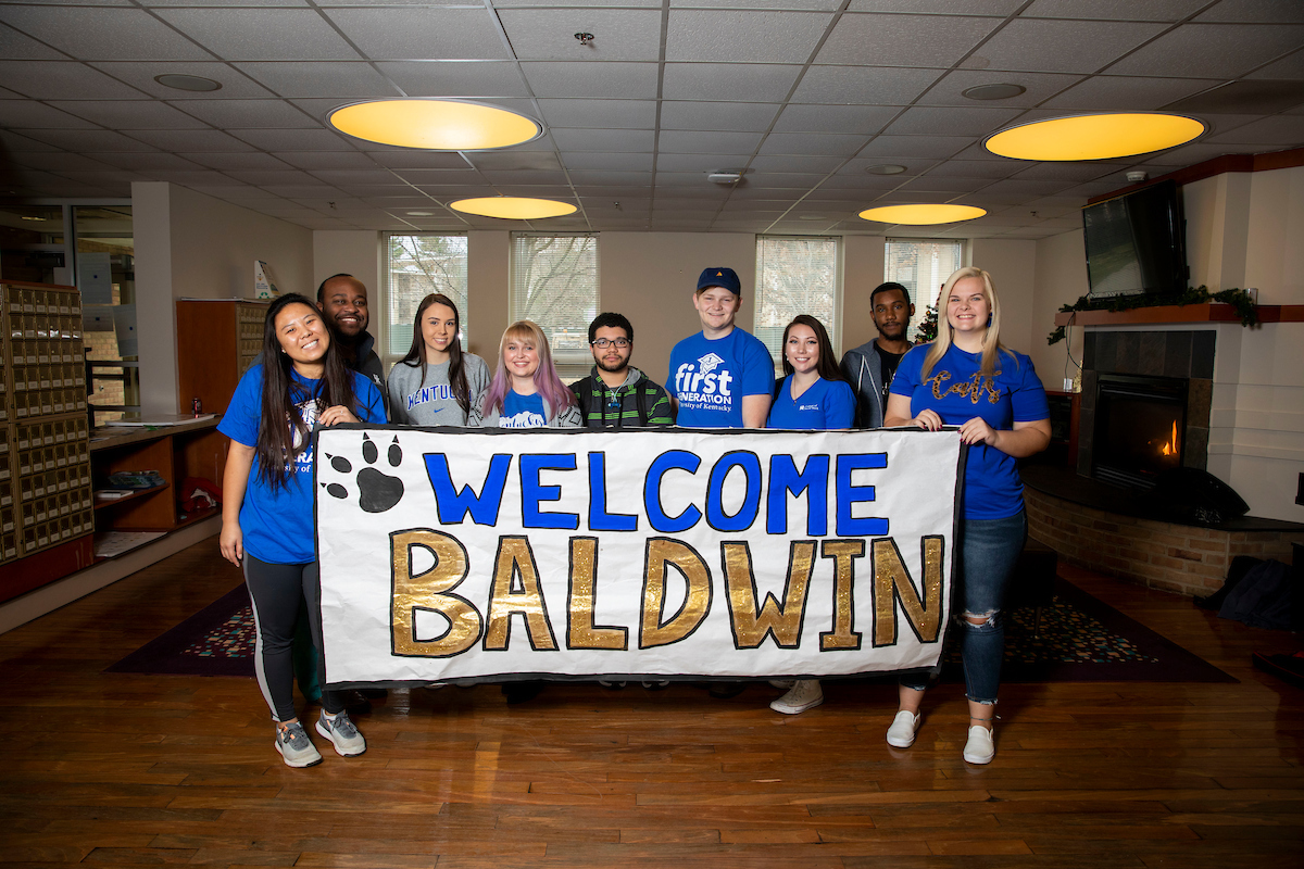First-generation students holding "Welcome Baldwin" sign
