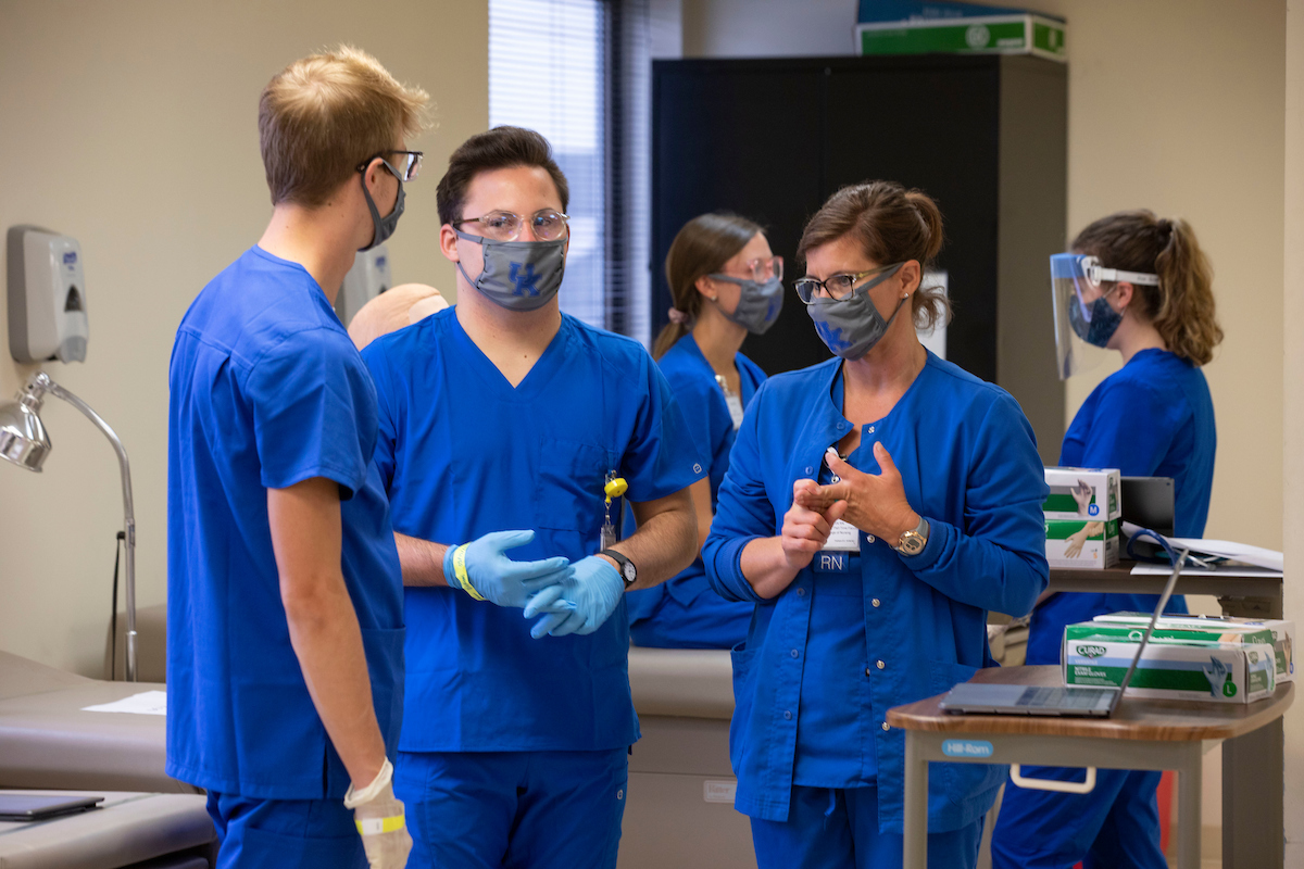 Nursing students chatting during lab simulation