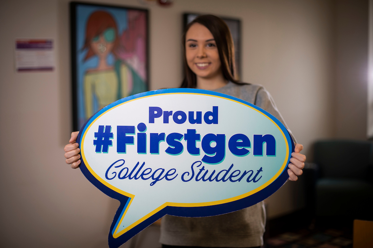 Student holding "Proud #Firstgen College Student" sign