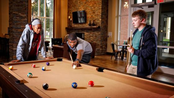 Students playing pool in a residence hall
