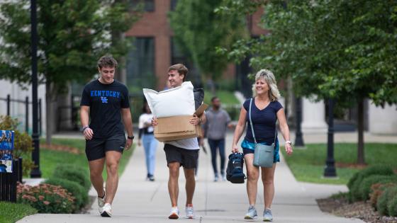 Family walking to their residence hall for move in.