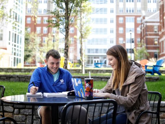 Students eating at table outside of Boyd and Holmes Halls