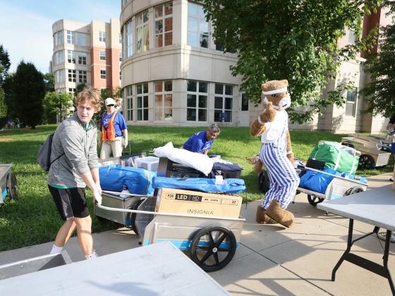 The Wildcat helps a student move in.