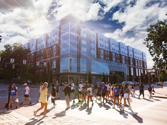 Students walking across the street in front of Holmes Hall