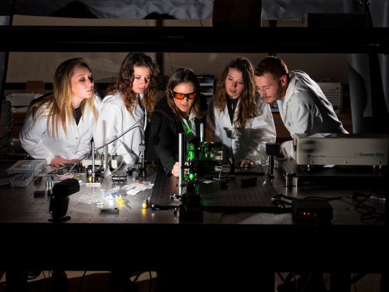 Engineering students observing professor