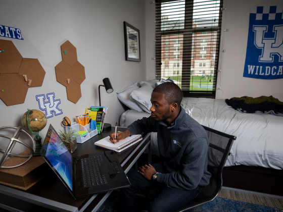 Student studying at desk in residence hall room