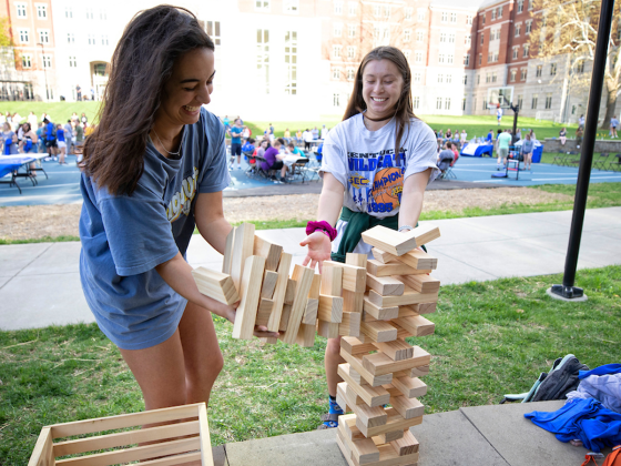 Students playing Jenga in Residence Hall courtyard