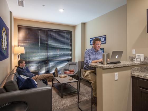 Two students in common area of 2-Bedroom Apartment