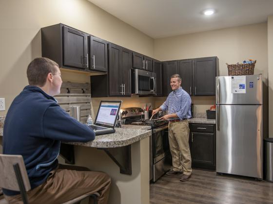 Two students in kitchen area of 2-Bedroom Apartment
