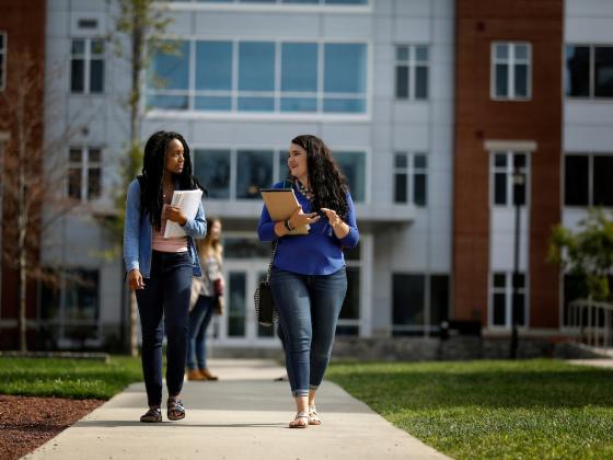 Two female students walking in front of Boyd Hall