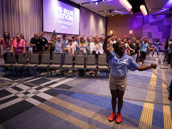 First Year Experience Ambassador leading the C-A-T-S cheer at Big Blue Orientation