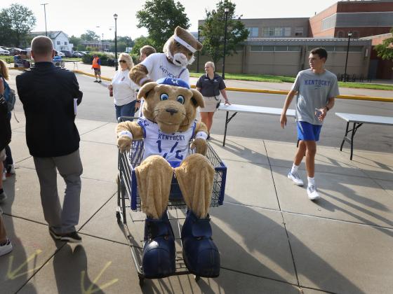 Wildcat mascot pushing Scratch mascot in grocery cart during Big Blue Move-In
