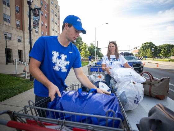 Male student loading belongings into cart during Big Blue Move-In