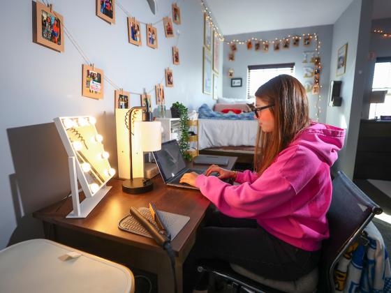 Student at desk in room of Donovan Hall